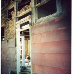 E2 A wall of original siding and doorway encapsulated inside a wall